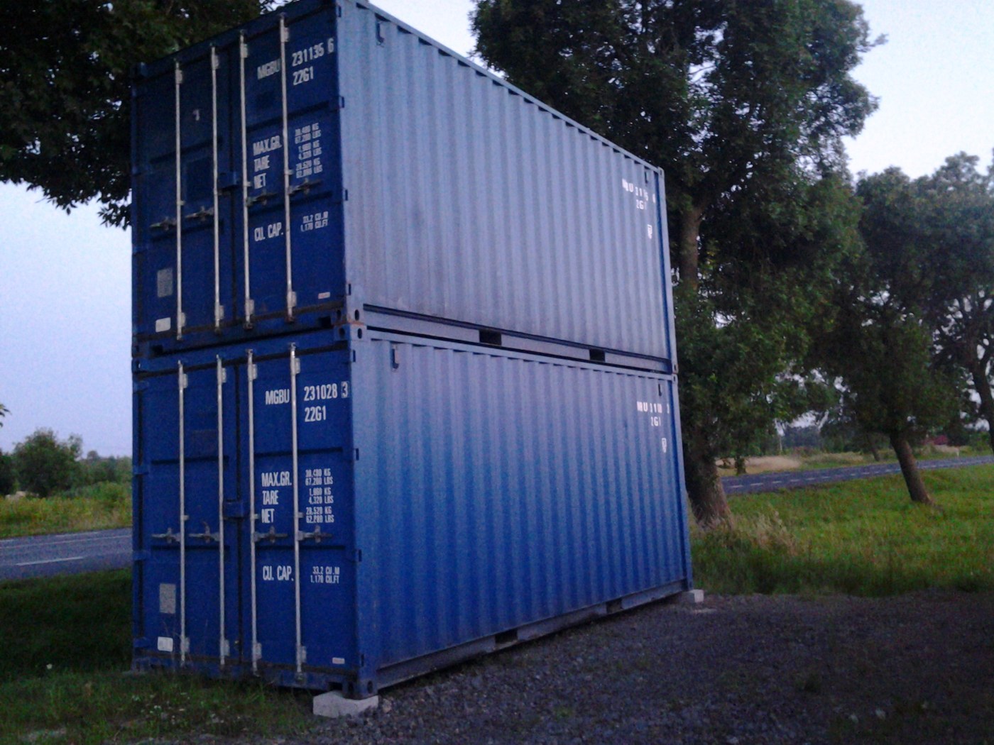 Photograph of two blue 20-foot shipping containers